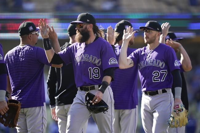 The Colorado Rockies celebrate after a 5-0 win over the Los Angeles Dodgers in a baseball game Sunday, Aug. 29, 2021, in Los Angeles. (AP Photo/Ashley Landis)