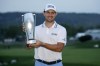 Patrick Cantlay holds the trophy after winning the BMW Championship golf tournament, Sunday, Aug. 29, 2021, at Caves Valley Golf Club in Owings Mills, Md. (AP Photo/Nick Wass)