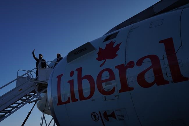 Liberal Leader Justin Trudeau waves from the steps of his campaign plane as he arrives in Iqaluit, Nunavut on Monday, August 30, 2021. THE CANADIAN PRESS/Nathan Denette