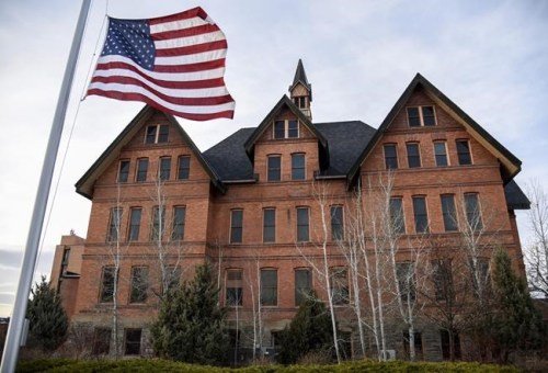FILE - In this April 2, 2021, file photo, a U.S. flag flies in front of Montana Hall at Montana State University in Bozeman, Mont. The university said Monday, Aug. 30 that the founders of an insurance company are donating $101 million to its nursing school. School officials said the donation is the largest gift to a university nursing program in U.S. history and will help the state deal with a shortage of nurses. (Rachel Leathe/Bozeman Daily Chronicle via AP, File)