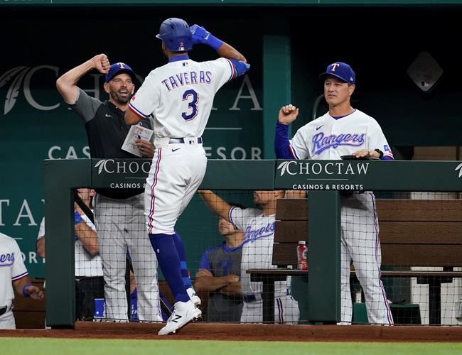 Texas Rangers manager Chris Woodward, left, and bench coach Don Wakamatsu, right, congratulate Leody Taveras (3) on his solo home run in the fifth inning of a baseball game against the Colorado Rockies in Arlington, Texas, Monday, Aug. 30, 2021. (AP Photo/Tony Gutierrez)