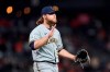 Milwaukee Brewers pitcher Corbin Burnes reacts after striking out San Francisco Giants' Buster Posey to end the sixth inning of a baseball game in San Francisco, Monday, Aug. 30, 2021. (AP Photo/Jeff Chiu)