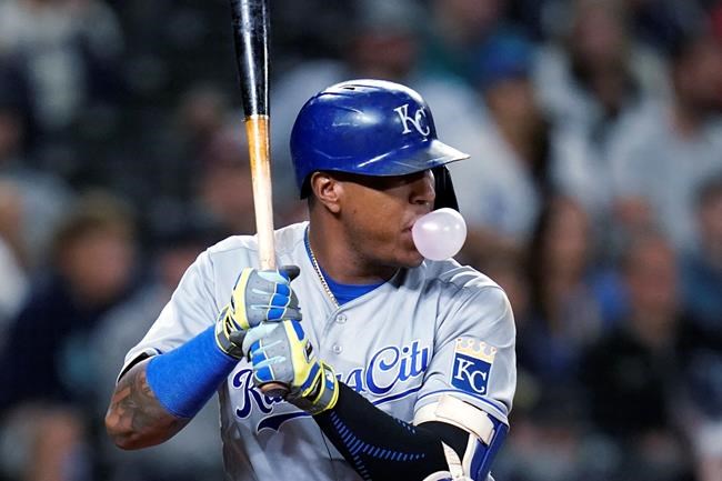 Kansas City Royals' Salvador Perez blows a bubble as he stands in the batter's box during the eighth inning against the Seattle Mariners in a baseball game Friday, Aug. 27, 2021, in Seattle. Perez flied out on at-bat. (AP Photo/Elaine Thompson)