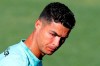 Portugal's Cristiano Ronaldo looks on after wetting his face with water, during a training session in Oeiras, Portugal, Monday, Aug. 30, 2021. Portugal will play Ireland on Wednesday in a Qatar 2022 World Cup qualifying match. (AP Photo/Armando Franca)