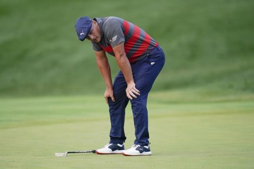 Bryson DeChambeau reacts after missing a putt on the 17th green, the third playoff hole against Patrick Cantlay during the final round of the BMW Championship golf tournament, Sunday, Aug. 29, 2021, at Caves Valley Golf Club in Owings Mills, Md. (AP Photo/Julio Cortez)