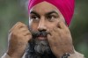 New Democratic leader Jagmeet Singh adjusts his moustache as he stands at the microphone during a campaign stop, Tuesday, August 31, 2021 in Coquitlam. THE CANADIAN PRESS/Adrian Wyld