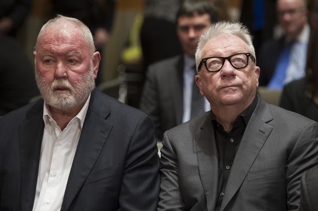 FILE - In this Jan. 10, 2017, file photo, former Backpage.com owners James Larkin, left, and Michael Lacey wait on Capitol Hill in Washington to appear at a congressional hearing examining the classified site. Larkin and Lacey are scheduled to go on trial Wednesday, Sept. 1, 2021, in Phoenix on charges of facilitating prostitution and money laundering in what authorities say was a scheme to knowingly run ads for sexual services. Lacey and Larkin pleaded not guilty to the charges, said the site never allowed ads for sex and maintain the site's content was protected by the First Amendment. (AP Photo/Cliff Owen)