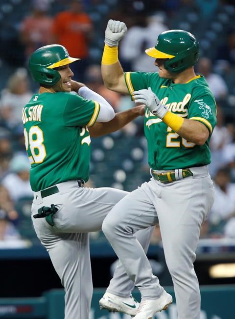 Oakland Athletics' Matt Chapman (26) celebrates with Matt Olson (28) after hitting a two-run home run against the Detroit Tigers during the third inning of a baseball game Tuesday, Aug. 31, 2021, in Detroit. (AP Photo/Duane Burleson)