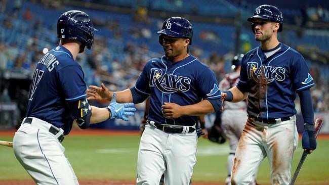 Tampa Bay Rays' Francisco Mejia, center, and Kevin Kiermaier, right, celebrate with Austin Meadows after Mejia and Kiermaier scored on an RBI single by Wander Franco off Boston Red Sox pitcher Brad Peacock during the third inning of a baseball game Tuesday, Aug. 31, 2021, in St. Petersburg, Fla. (AP Photo/Chris O'Meara)