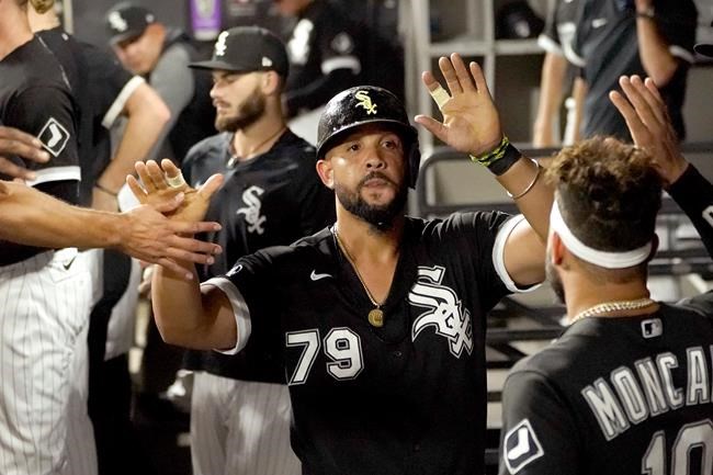 Chicago White Sox's Jose Abreu is greeted in the dugout after he scored on a bases loaded walk by Pittsburgh Pirates relief pitcher Chasen Shreve during the sixth inning of a baseball game Tuesday, Aug. 31, 2021, in Chicago. (AP Photo/Charles Rex Arbogast)