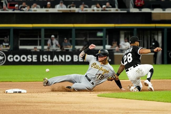 Pittsburgh Pirates' Ben Gamel (18) steals second on a throw from Chicago White Sox catcher Yasmani Grandal to Leury Garcia during the first inning of a baseball game Tuesday, Aug. 31, 2021, in Chicago. Gamel advanced to third on Grandal's throwing error. (AP Photo/Charles Rex Arbogast)