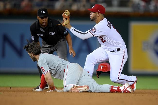 Philadelphia Phillies' Bryce Harper looks up after being put out at second by Washington Nationals shortstop Luis Garcia (2) after he hit a two-run single during the sixth inning of a baseball game Tuesday, Aug. 31, 2021, in Washington. (AP Photo/Nick Wass)