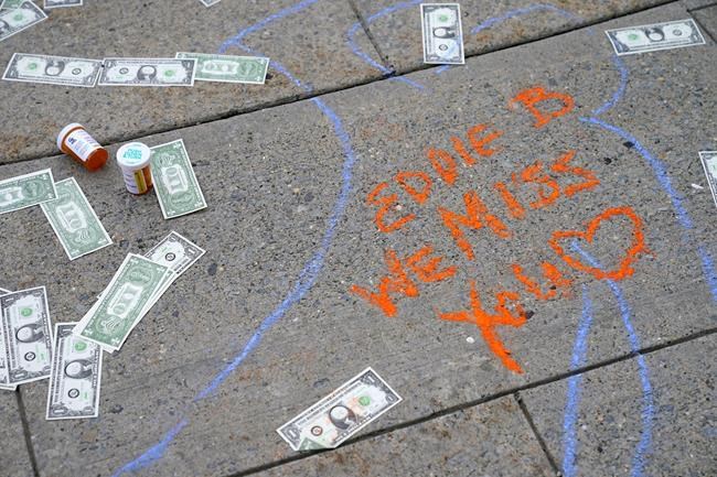 FILE - In this Aug. 9, 2021, file photo, the outline of a protester's body with a message is seen on the sidewalk outside the courthouse where the Purdue Pharma bankruptcy is taking place in White Plains, N.Y. A federal bankruptcy judge is expected to rule Wednesday, Sept. 1, on whether to accept a settlement between OxyContin maker Purdue Pharma, the states and thousands of local governments over an opioid crisis that has killed a half-million Americans over the last two decades. (AP Photo/Seth Wenig, File)