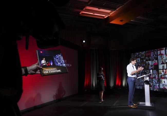 Liberal Leader Justin Trudeau speaks about his new campaign platform as a CBC camera man video tapes the Liberal platform book during the Canadian federal election in Toronto on Wednesday, September 1, 2021. THE CANADIAN PRESS/Nathan Denette