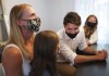 Liberal Leader Justin Trudeau, centre, talks with eighth-year-old Mila Greco, second left, and and her mom Trisha Greco, left, at their home before announcing mental health funding at campaign stop during the Canadian federal election in Kanata, Ont., on Tuesday, August 31, 2021. THE CANADIAN PRESS/Nathan Denette