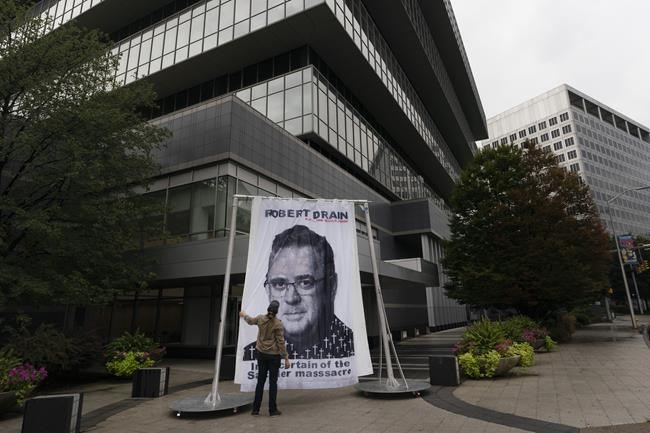 An image of federal bankruptcy judge Robert Drain is installed by protesters in front of Purdue Pharma's headquarters, Wednesday, Sept. 1, 2021 in Stamford, Conn. The judge is preparing to rule on a plan for OxyContin maker Purdue Pharma to settle lawsuits brought by governments and others over its role in the opioid crisis. (AP Photo/Mark Lennihan)