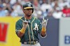 FILE - In this Sept. 1, 2019, file photo, Oakland Athletics designated hitter Khris Davis gestures to his teammates after hitting a double in the seventh inning of a baseball game against the New York Yankees in New York. Davis was promoted by the Athletics as a September call-up Wednesday, Sept. 1, 2021, bringing his hot bat from Triple-A Las Vegas, hoping to contribute to a fourth straight playoff run for the club that traded him to division opponent Texas nearly seven months ago. (AP Photo/Kathy Willens, File)