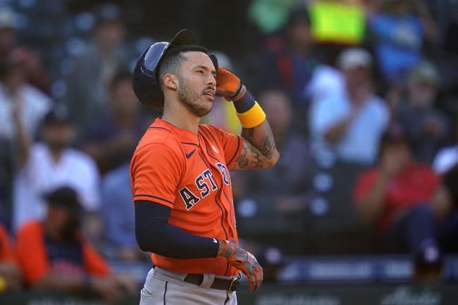 Houston Astros' Carlos Correa stands at home and pulls off his batting helmet after striking out looking against the Seattle Mariners to end the top of the eighth inning of a baseball game Wednesday, Sept. 1, 2021, in Seattle. (AP Photo/Elaine Thompson)