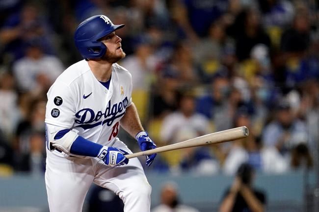 Los Angeles Dodgers' Max Muncy watches his triple during the third inning of the team's baseball game against the Atlanta Braves on Wednesday, Sept. 1, 2021, in Los Angeles. (AP Photo/Marcio Jose Sanchez)