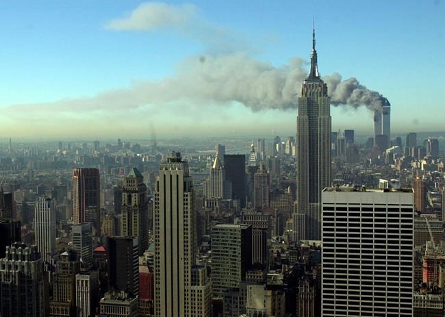 Smoke billows across the New York City skyline after two hijacked planes crashed into the twin towers on Sept. 11, 2001. Most Americans were guided through the events of the day by one of three men: Tom Brokaw of NBC News, Peter Jennings of ABC and Dan Rather of CBS. Each had extensive reporting experience before that, Brokaw and Rather were at the White House during Watergate, and Jennings has been a foreign correspondent. (AP Photo/Patrick Sison, File)