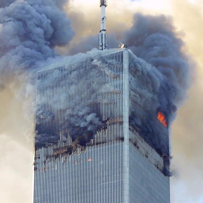FILE - Fire and smoke billows from the north tower of New York's World Trade Center on Sept. 11, 2001 after terrorists crashed two hijacked airliners into the World Trade Center and brought down the twin towers. Most Americans were guided through the events of the day by one of three men: Tom Brokaw of NBC News, Peter Jennings of ABC and Dan Rather of CBS. Each had extensive reporting experience before that, Brokaw and Rather were at the White House during Watergate, and Jennings has been a foreign correspondent. (AP Photo/David Karp, File)