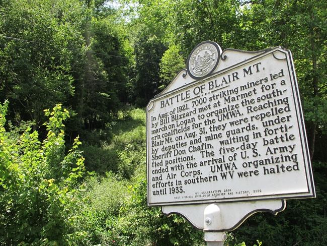 FILE - In this June 6, 2011 file photo, a historical marker along W.Va. Route 17 in Blair, W.Va., describes the 1921 battle between thousands of armed, unionizing coal miners and the law enforcement officers and security guards hired to defeat them. At least 16 men died on the mountain. (AP Photo/Vicki Smith, file)