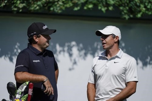 Patrick Reed, left, and Rory McIlroy, right, talk on the first tee during practice at the Tour Championship golf tournament on Wednesday, Sept. 1, 2021, at East Lake Golf Club in Atlanta. (AP Photo/Brynn Anderson)