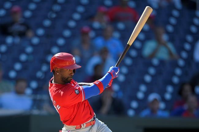 Philadelphia Phillies' Andrew McCutchen follows through with an RBI single during the eighth inning of a baseball game against the Washington Nationals, Thursday, Sept. 2, 2021, in Washington. Phillies' J.T. Realmuto scored on the play. The Phillies won 7-6. (AP Photo/Nick Wass)