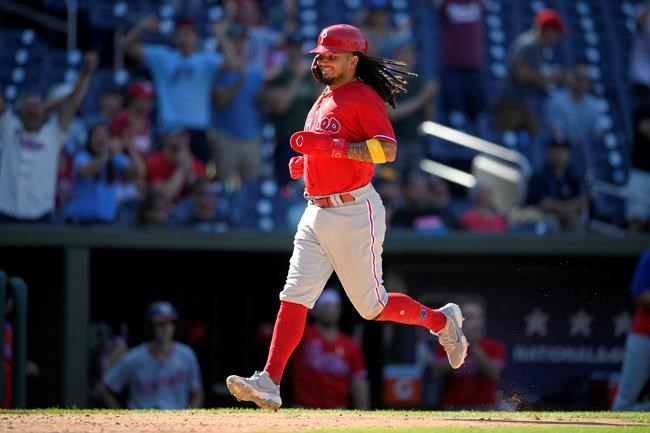 Philadelphia Phillies' Freddy Galvis comes in to score on a fielder's choice by Nick Maton during the eighth inning of a baseball game against the Washington Nationals, Thursday, Sept. 2, 2021, in Washington. The Phillies won 7-6. (AP Photo/Nick Wass)