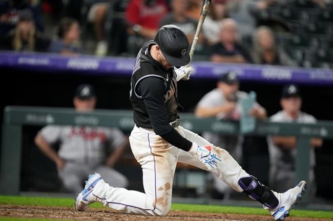 Colorado Rockies' Trevor Story lands on a knee in the batter's box after swinging and missing at a pitch from Atlanta Braves' Luke Jackson during the eighth ninth inning of a baseball game Thursday, Sept. 2, 2021, in Denver. The Braves won 6-5. (AP Photo/David Zalubowski)