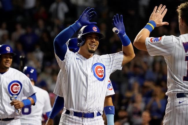 Chicago Cubs' Rafael Ortega, center, celebrates with Patrick Wisdom, right, after hitting a three-run home run during the seventh inning of a baseball game against the Pittsburgh Pirates in Chicago, Thursday, Sept. 2, 2021. (AP Photo/Nam Y. Huh)