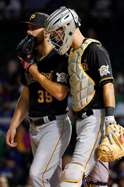Pittsburgh Pirates relief pitcher Chad Kuhl, left, talks with catcher Jacob Stallings during the seventh inning of a baseball game against the Chicago Cubs in Chicago, Thursday, Sept. 2, 2021. (AP Photo/Nam Y. Huh)