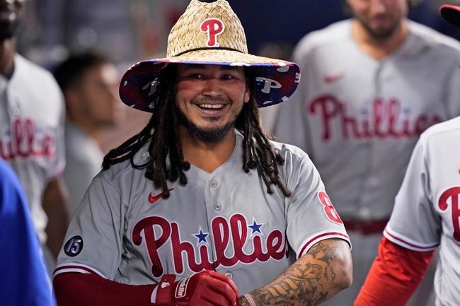 Philadelphia Phillies' Freddy Galvis smiles after being congratulated by teammates after he hit a home run during the first inning of the team's baseball game against the Miami Marlins, Friday, Sept. 3, 2021, in Miami. (AP Photo/Wilfredo Lee)