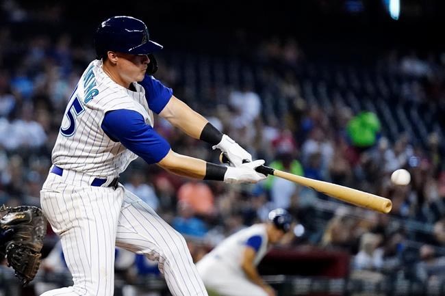 Arizona Diamondbacks' Andrew Young hits an RBI double against the Seattle Mariners during the seventh inning of a baseball game Friday, Sept. 3, 2021, in Phoenix. (AP Photo/Ross D. Franklin)