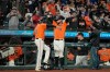 San Francisco Giants' Brandon Belt (9) celebrates with third base coach Ron Wotus (8) after the replay showed that Buster Posey was safe at first base for a 3-2 victory against the Los Angeles Dodgers Friday, Sept. 3, 2021, in San Francisco. (AP Photo/Tony Avelar)