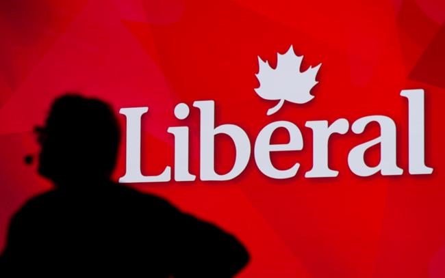 A Liberal Party of Canada logo is shown on a giant screen as a technician looks on during day one of the party's biennial convention in Montreal, Thusday, Feb. 20, 2014. THE CANADIAN PRESS/Graham Hughes