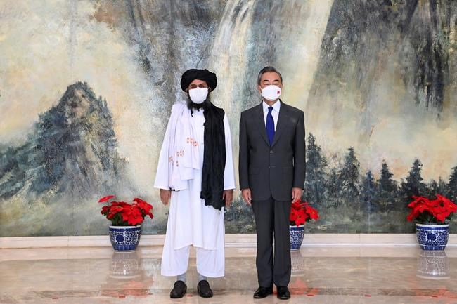 Taliban co-founder Mullah Abdul Ghani Baradar, left, and Chinese Foreign Minister Wang Yi pose for a photo during their meeting in Tianjin, China, in a July 28, 2021, photo released by China's Xinhua News Agency. With the United States and its allies, Canada included, having left Afghanistan firmly in the hands of the Taliban, another world power is stepping into the void to exert its influence on the troubled country – China. THE CANADIAN PRESS/AP-Xinhua, Li Ran