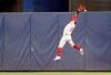 Philadelphia Phillies center fielder Odubel Herrera can't catch a fly ball hit by Miami Marlins' Miguel Rojas during the first inning of a baseball game Saturday, Sept. 4, 2021, in Miami. (AP Photo/Rhona Wise)