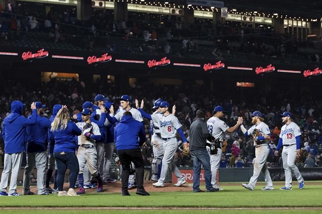 Los Angeles Dodgers celebrate after defeating the San Francisco Giants in a baseball game in San Francisco, Saturday, Sept. 4, 2021. The Dodgers won 6-1. (AP Photo/John Hefti)