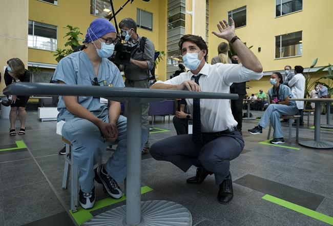 Liberal Leader Justin Trudeau, right, talks with health-care workers as he makes a campaign stop at a hospital during the Canadian federal election campaign in Toronto on Sunday, September 5, 2021. THE CANADIAN PRESS/Nathan Denette