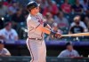 Atlanta Braves' Austin Riley follows the flight of his two-run home run off Colorado Rockies relief pitcher Julian Fernandez in the seventh inning of a baseball game Sunday, Sept. 5, 2021, in Denver. (AP Photo/David Zalubowski)