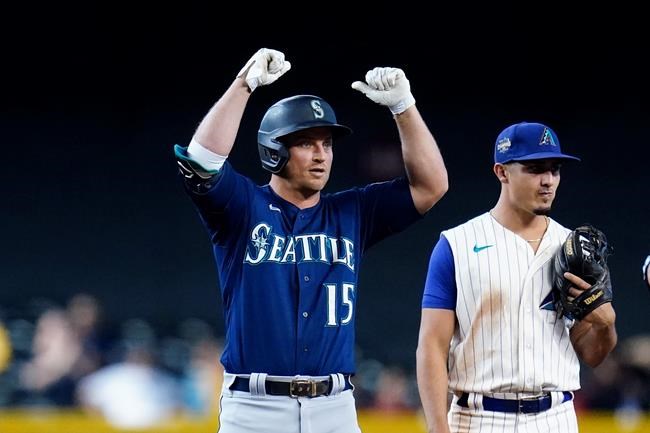 Seattle Mariners' Kyle Seager (15) celebrates his two-run double as he stand on second base next to Arizona Diamondbacks shortstop Josh Rojas during the 11th inning of a baseball game Sunday, Sept. 5, 2021, in Phoenix. (AP Photo/Ross D. Franklin)