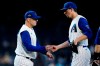 Arizona Diamondbacks manager Torey Lovullo, left, takes the ball from relief pitcher Taylor Clarke, right, during the 11th inning of a baseball game against the Seattle Mariners, Sunday, Sept. 5, 2021, in Phoenix. (AP Photo/Ross D. Franklin)