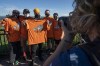 New Democratic Party Leader Jagmeet Singh gets his picture taken as he is presented with a t-shirt in support of Indigenous children and residential school survivors during an election campaign stop in Hamilton, Ont., Monday, Sept. 6, 2021. The three main party leaders are promising better working conditions and more benefits for Canadian workers along with additional support for businesses during election campaign events on Labour Day. THE CANADIAN PRESS/Jonathan Hayward
