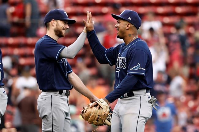 Tampa Bay Rays' Wander Franco, right, celebrates with relief pitcher Collin McHugh after they defeated the Boston Red Sox in 10 innings of a baseball game Monday, Sept. 6, 2021, at Fenway Park in Boston. (AP Photo/Winslow Townson)