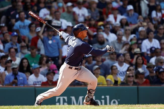 Tampa Bay Rays' Wander Franco follows through on a single against the Boston Red Sox during the third inning of a baseball game Monday, Sept. 6, 2021, at Fenway Park in Boston. (AP Photo/Winslow Townson)