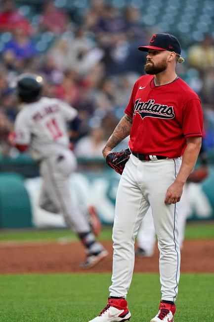 Cleveland Indians starting pitcher Logan Allen, right, waits for Minnesota Twins' Jorge Polanco, back left, to run the bases after hitting a solo home run in the third inning of a baseball game, Monday, Sept. 6, 2021, in Cleveland. (AP Photo/Tony Dejak)