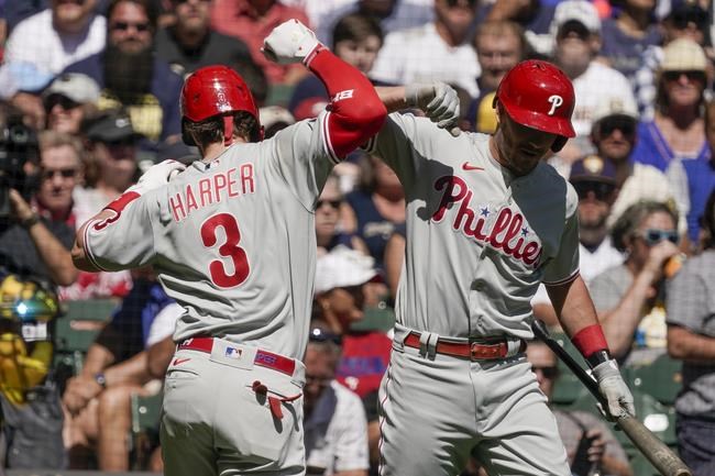 Philadelphia Phillies' Bryce Harper is congratulated by teammate J.T. Realmuto after hitting a two-run home run during the first inning of a baseball game against the Milwaukee Brewers Monday, Sept. 6, 2021, in Milwaukee. (AP Photo/Morry Gash)