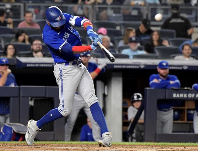Toronto Blue Jays' Lourdes Gurriel Jr. hits an RBI sacrifice fly during the fourth inning of the team's baseball game against the New York Yankees on Tuesday, Sept. 7, 2021, at Yankee Stadium in New York. (AP Photo/Bill Kostroun)