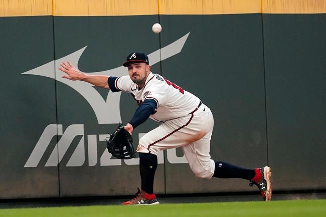 A ball hit for a ground-rule double by Washington Nationals' Yadiel Hernandez bounces away from Atlanta Braves left fielder Adam Duvall during the fourth inning of a baseball game Tuesday, Sept. 7, 2021, in Atlanta. (AP Photo/John Bazemore)